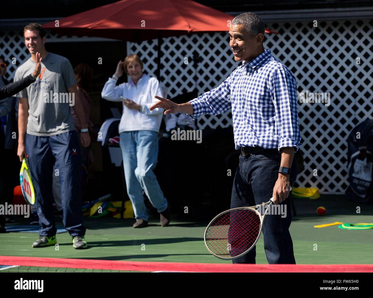 U.S President Barack Obama reacts during a tennis clinic on the White House tennis court during the annual Easter Egg Roll March 28, 2016 in Washington, DC. Stock Photo