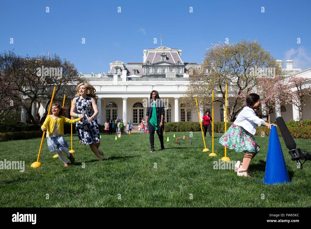 U.S First Lady Michelle Obama oversees obstacle course activity in the Rose Garden during the annual Easter Egg Roll March 28, 2016 in Washington, DC. Stock Photo