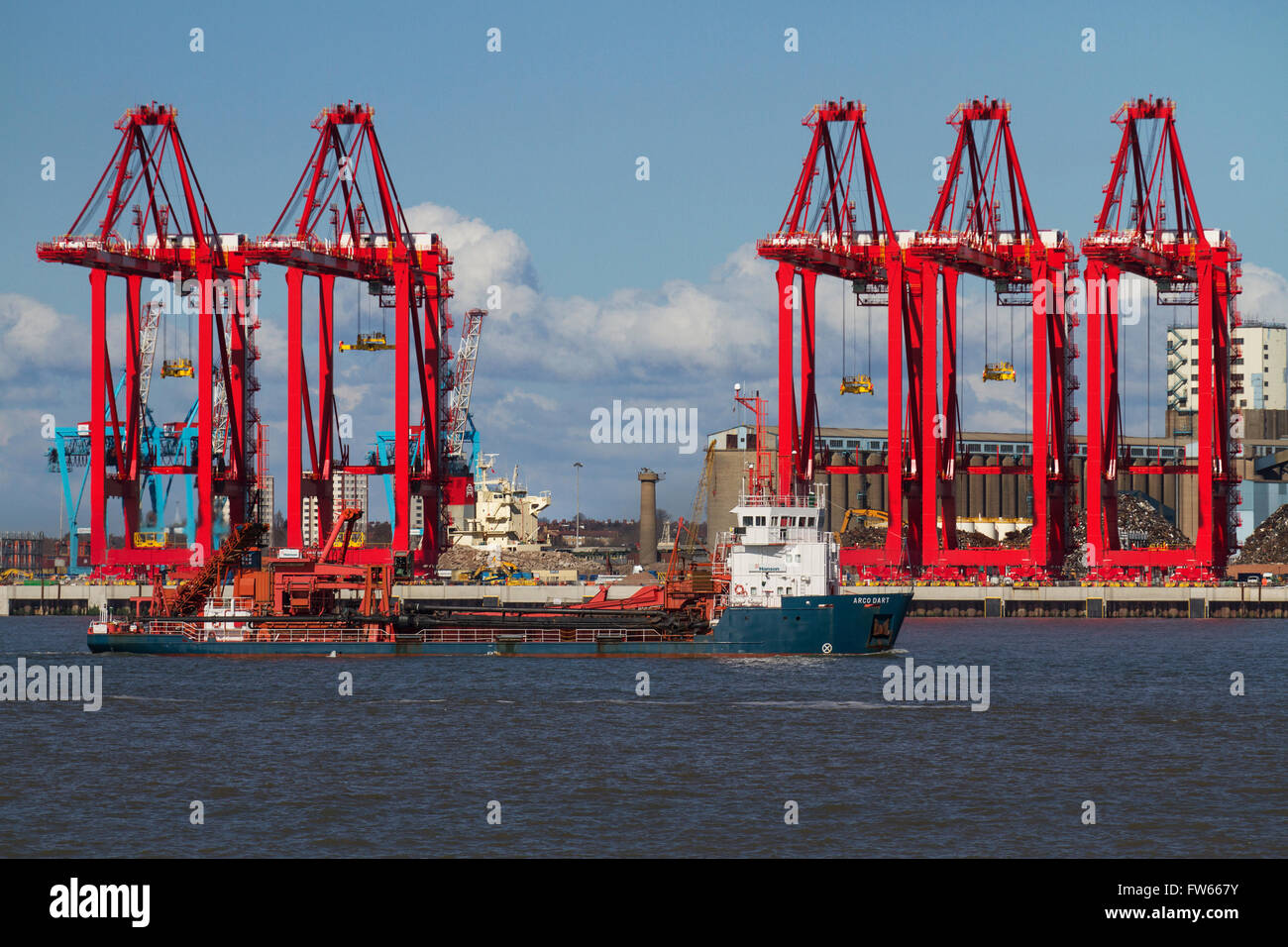 Container port operational cantilever rail-mounted gantry (CRMG) cranes and ship at Seaforth Dock, Liverpool, Wallasey, Merseyside, UK Stock Photo