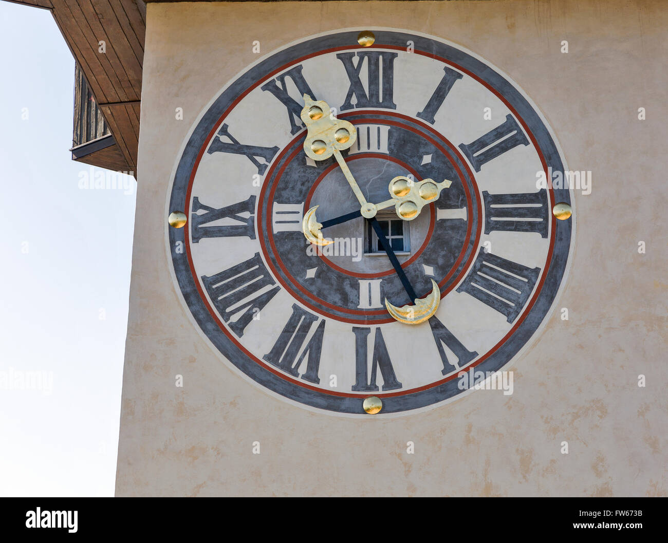 old wall outdoor clock with window on tower Uhrturm closeup. Schlossberg fortress in Graz, Austria Stock Photo