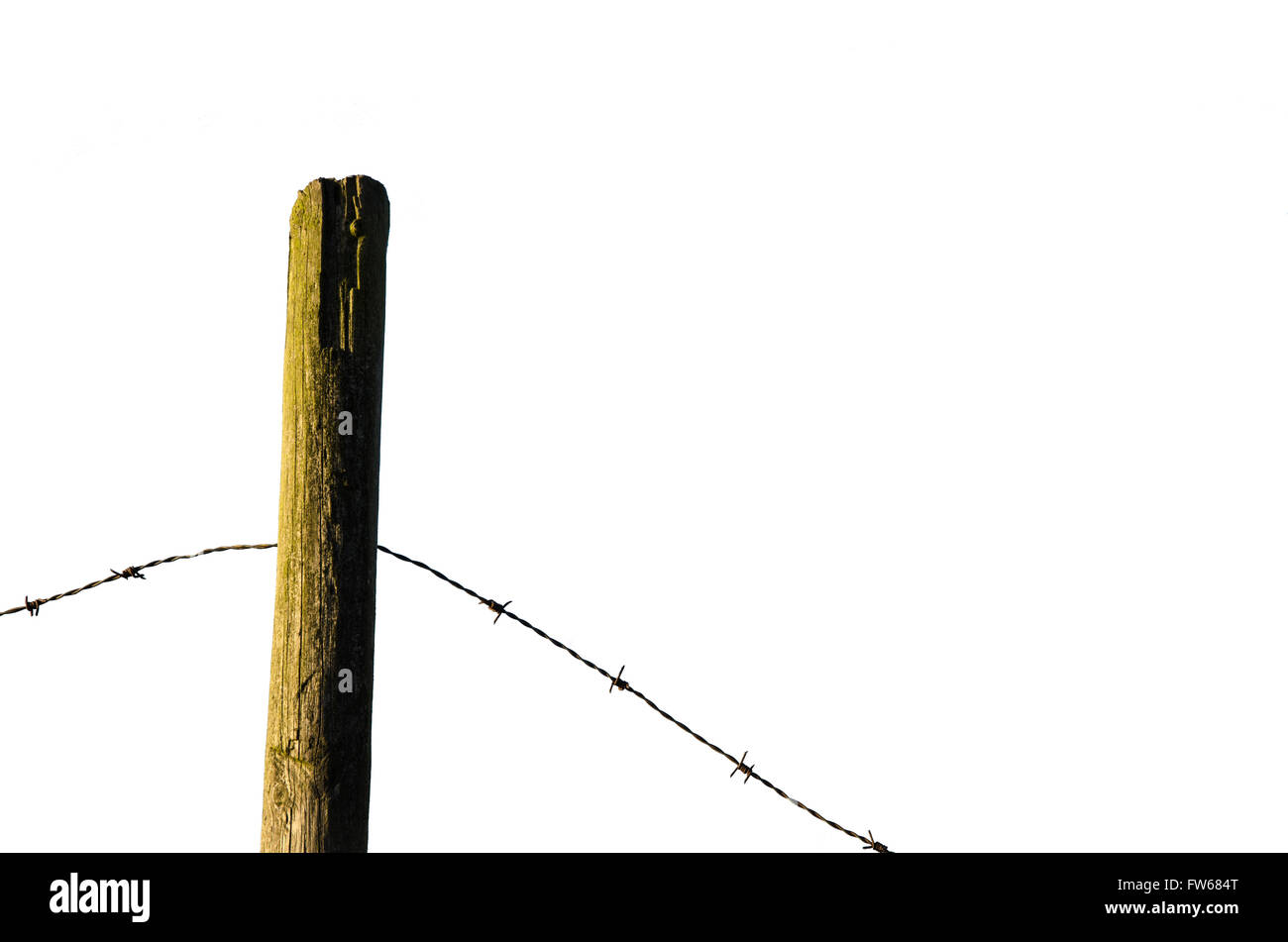Fence post with old barb wire isolated on white background Stock Photo