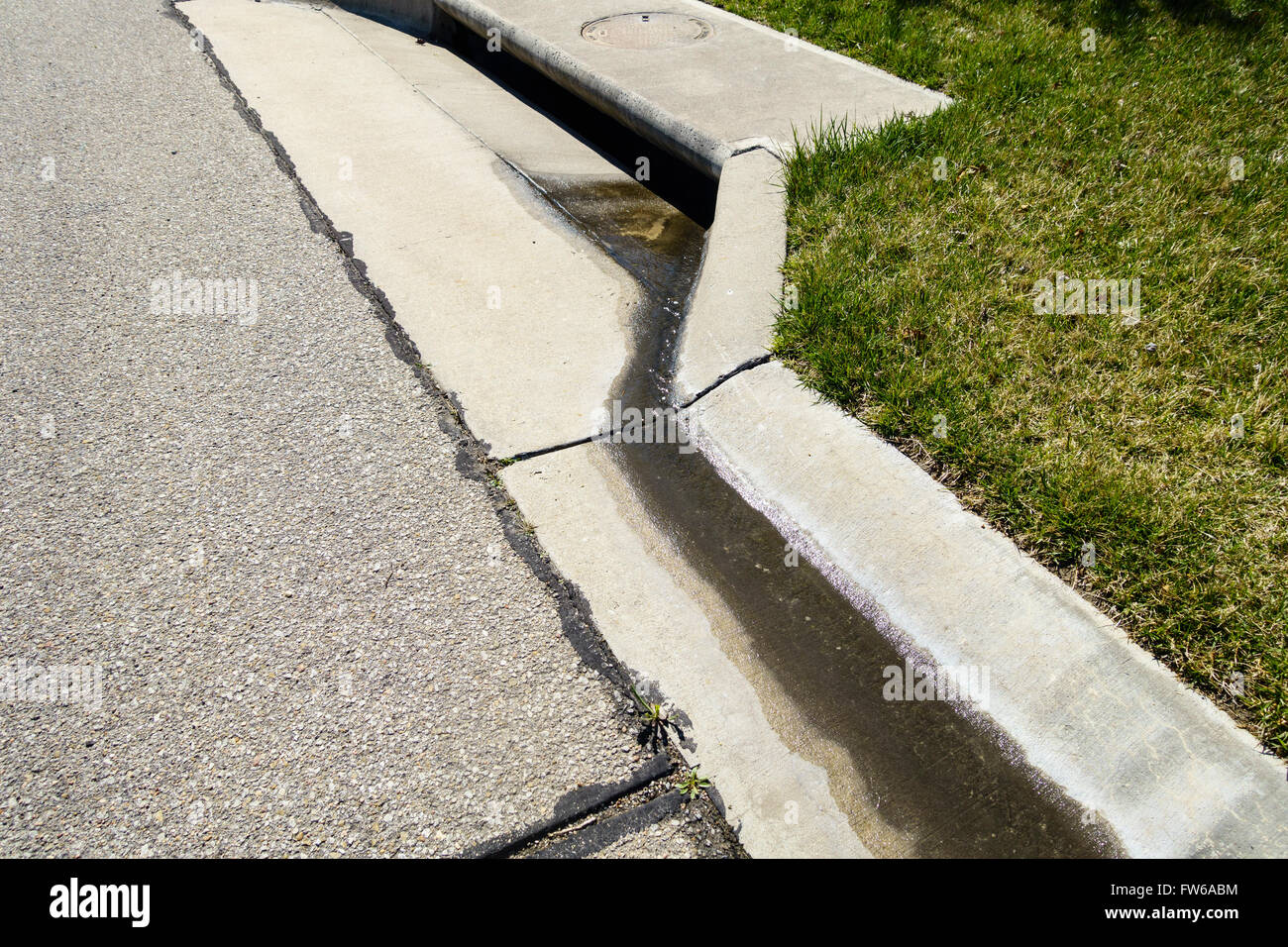 A curbside storm drain on an urban street in Wichita, Kansas. Stock Photo