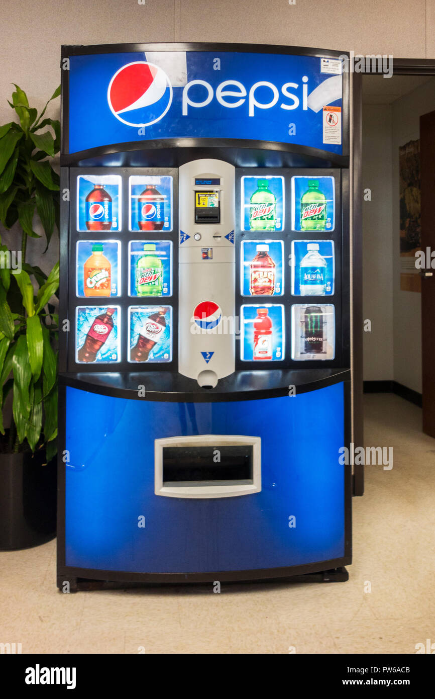 A coin-operated Pepsi vending machine dispensing cans of soft drinks and water. Stock Photo