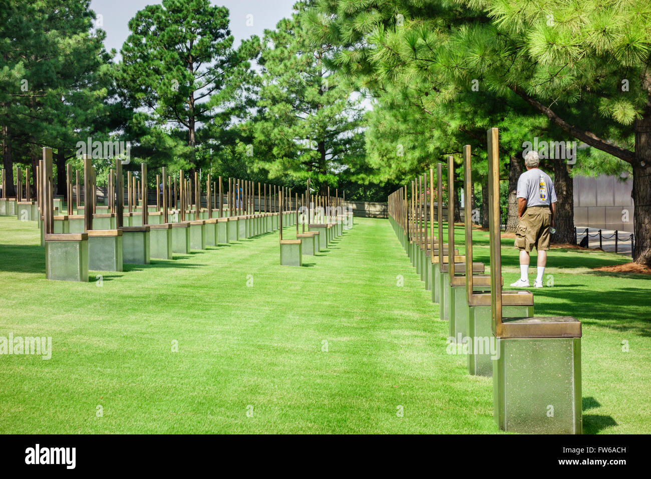 Vistors walk the grounds of the Field of Chairs honoring victims of the Oklahoma City bombing. Oklahoma City, Oklahoma, USA. Stock Photo