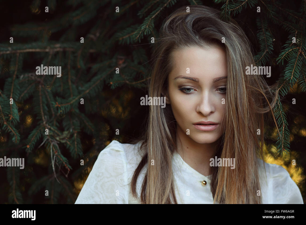 Beautiful young woman lost in her thoughts . Loneliness and melancholy Stock Photo