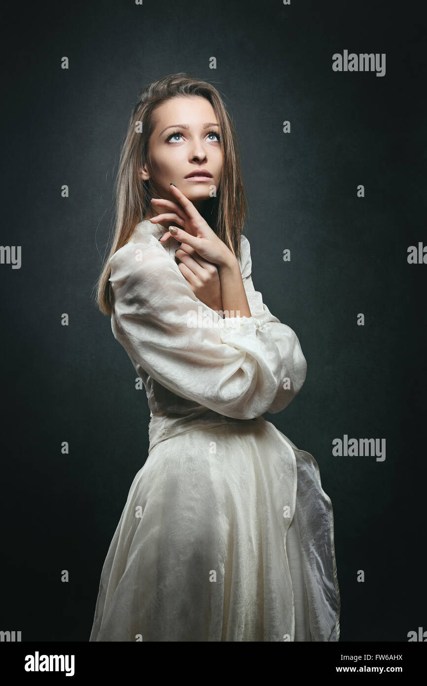 Beautiful woman with eyes to the sky. Victorian dress Stock Photo