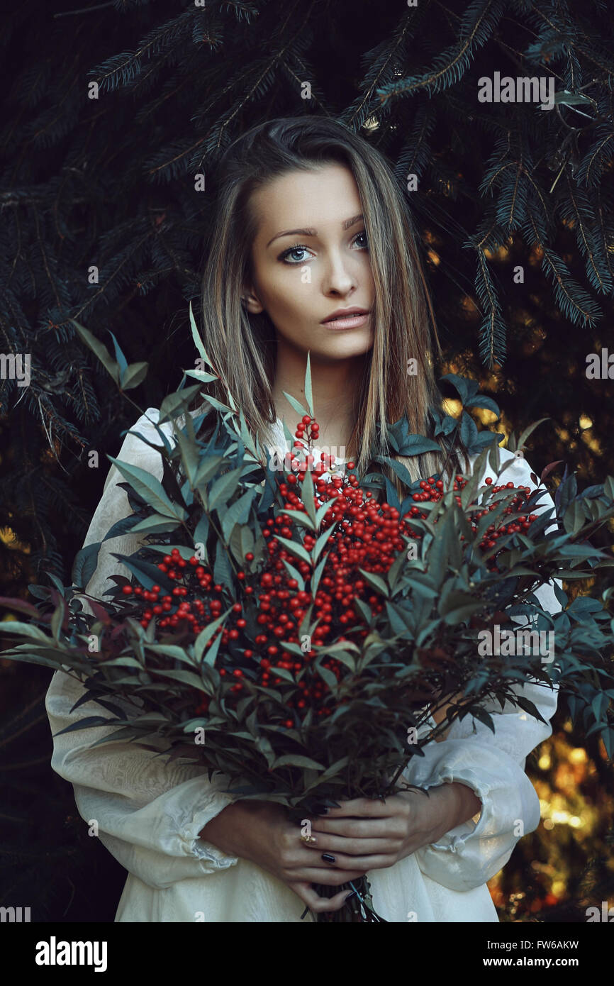 Winter portrait of beautiful woman  . Pine branches as background Stock Photo