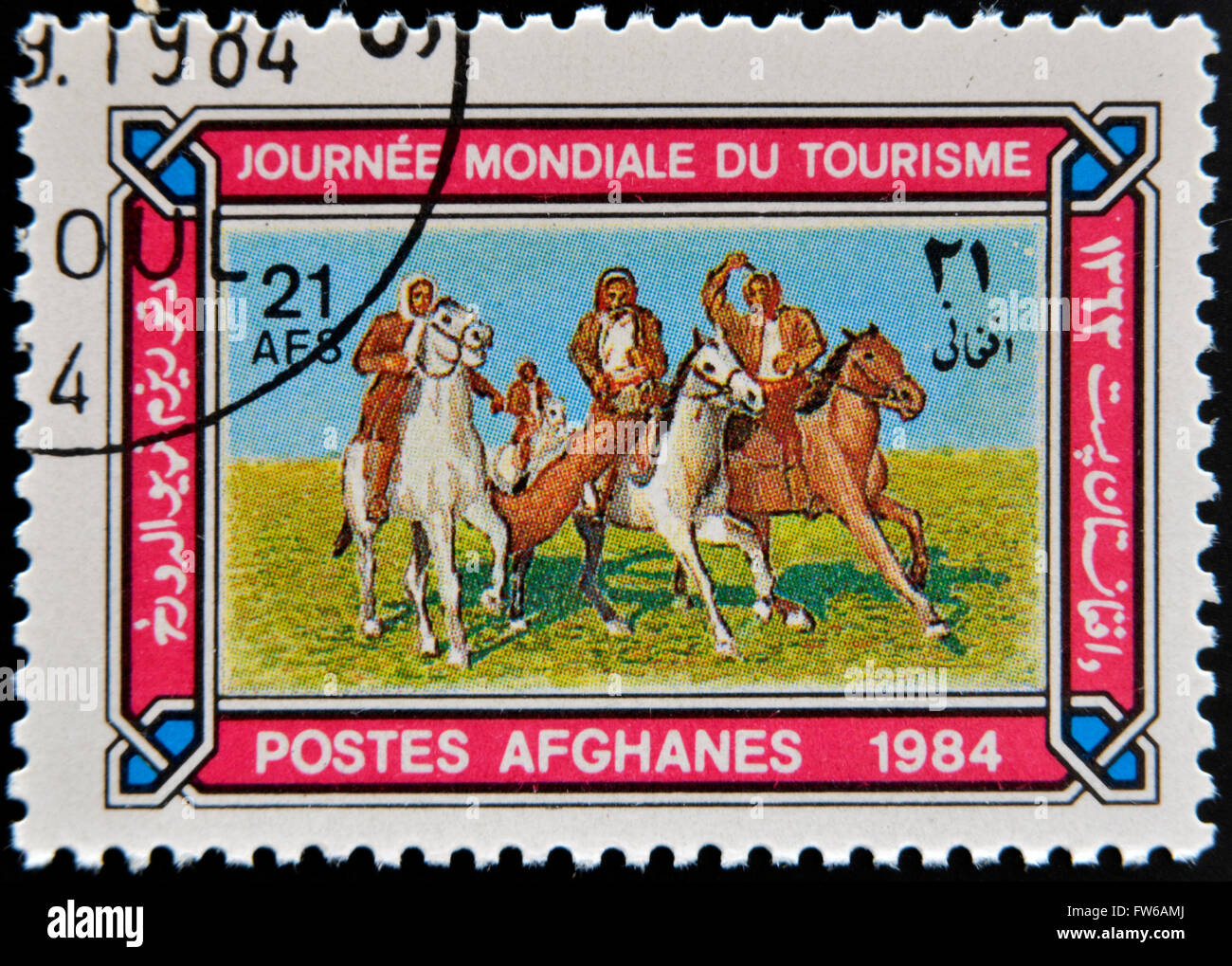 AFGHANISTAN - CIRCA 1984: A stamp printed in Afghanistan shows Horsemen playing Tourism buzkashi, circa 1984 Stock Photo