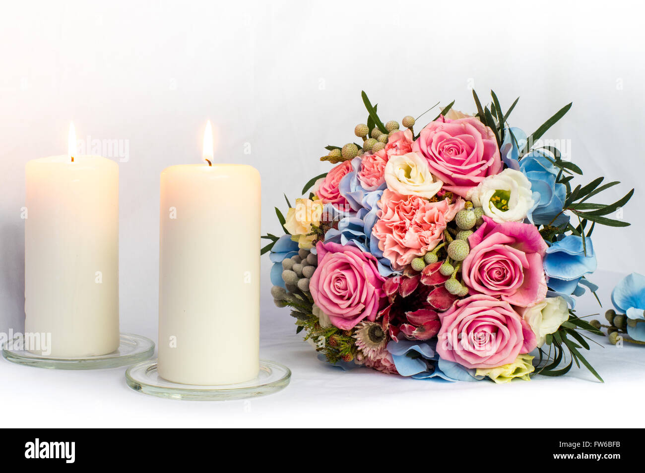 Colorful bouquet of the bride and burning candles, decoration for