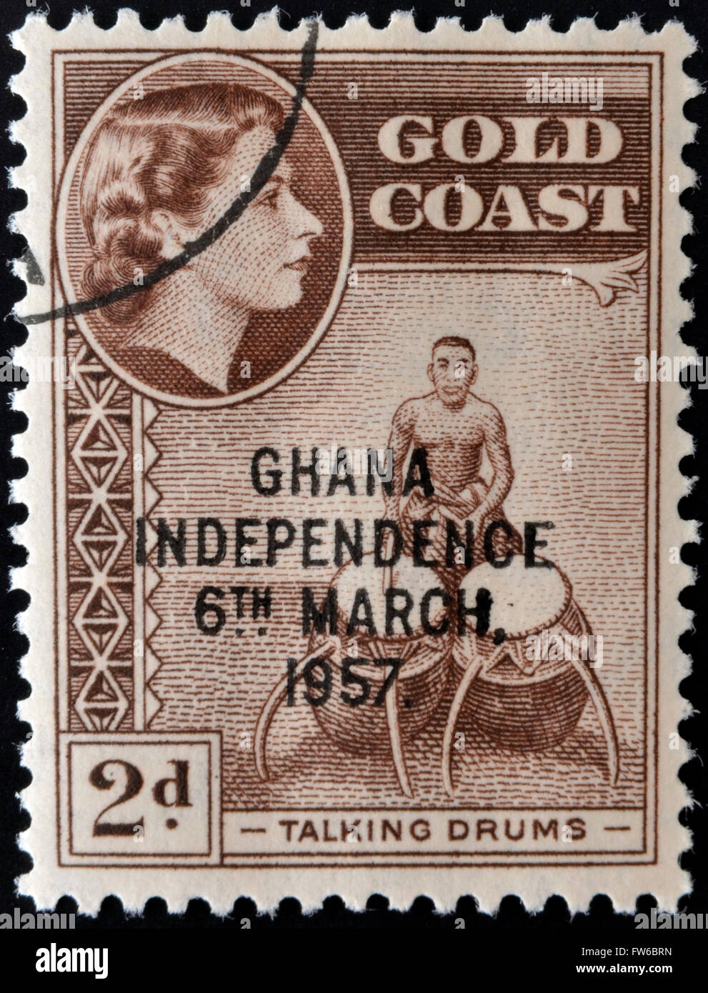 GOLD COAST - CIRCA 1952: A stamp printed in Gold Coast shows Queen Elizabeth and talking drums, circa 1952 Stock Photo