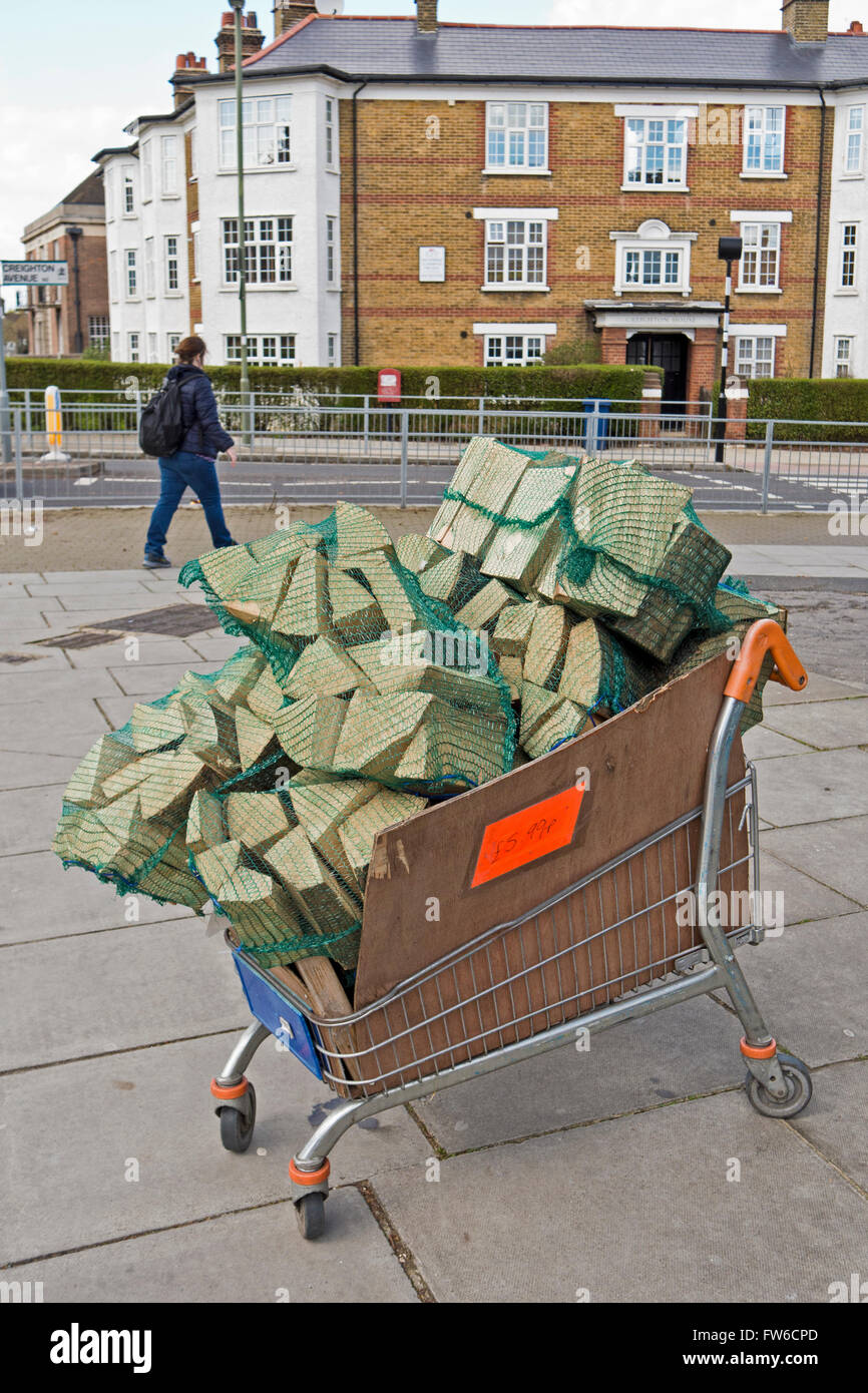 A shopping trolley loaded with firewood for sale Stock Photo