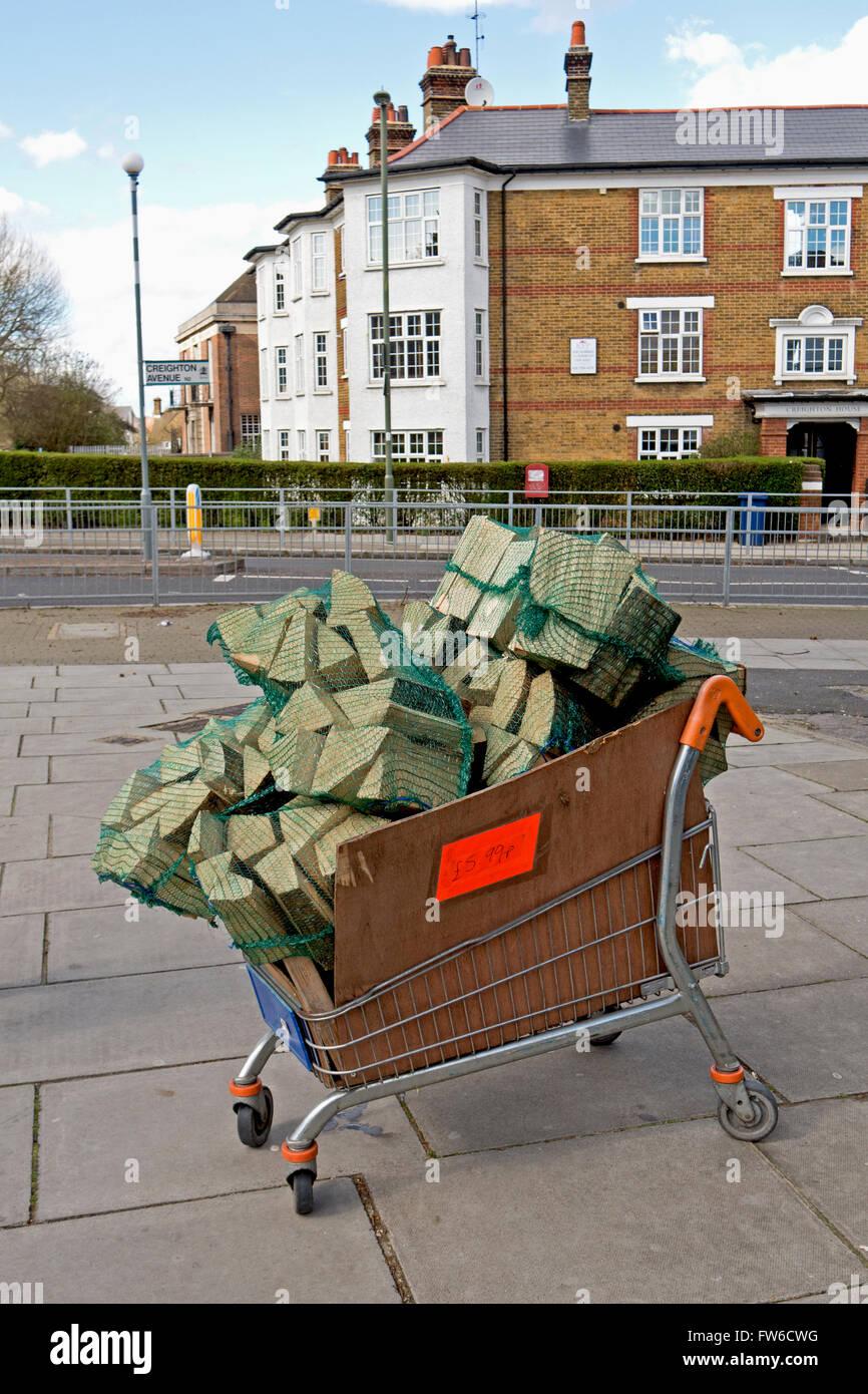 A supermarket shopping trolley full of firewood. Stock Photo