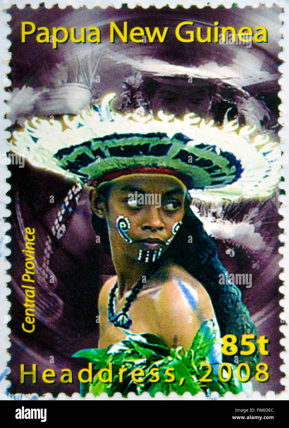 PAPUA NEW GUINEA - CIRCA 2000: Stamp printed in Papua New Guinea shows a woman in a feathered headdress Stock Photo