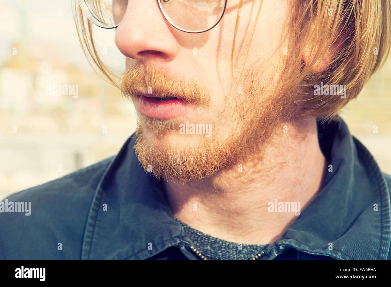 Closeup Of Young Man With Red Long Hair Beard And Glasses