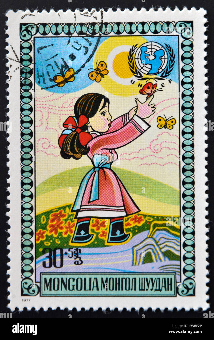 MONGOLIA - CIRCA 1977: stamp printed in Mongolia shows Girl chasing butterflies, circa 1977 Stock Photo