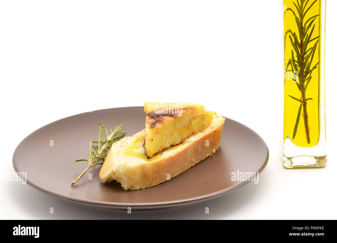 Spanish tortilla (omelet with potatoes and onions) on a slice of bread and olive oil Stock Photo