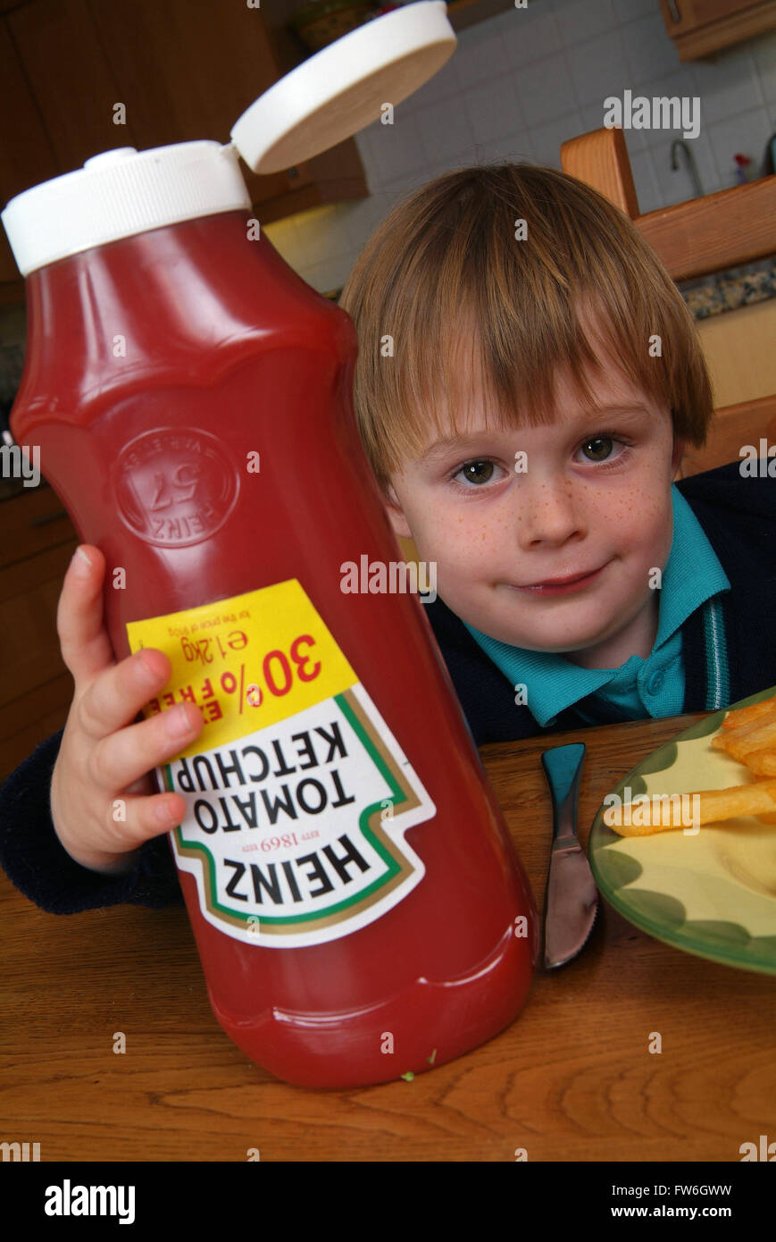 Young boys using Heinz tomato ketchup Stock Photo Alamy