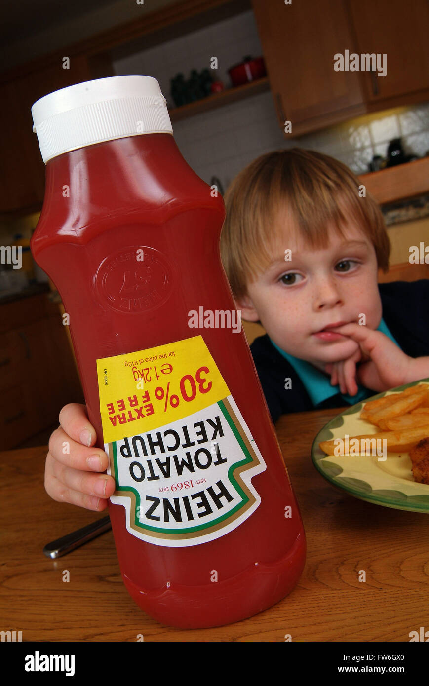 Young boys using Heinz tomato ketchup Stock Photo Alamy