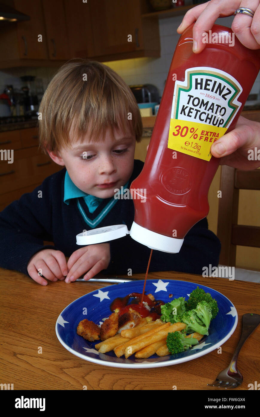 Young boys using Heinz tomato ketchup Stock Photo Alamy
