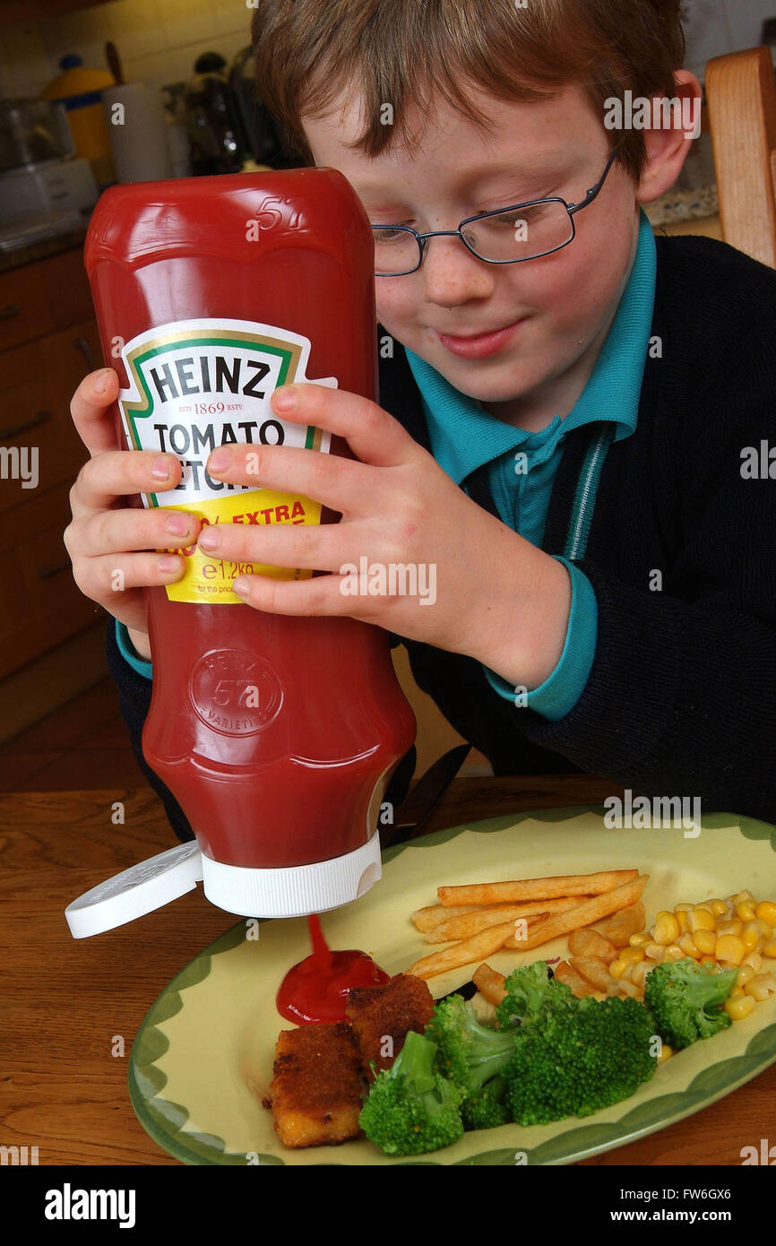 Young boys using Heinz tomato ketchup Stock Photo Alamy