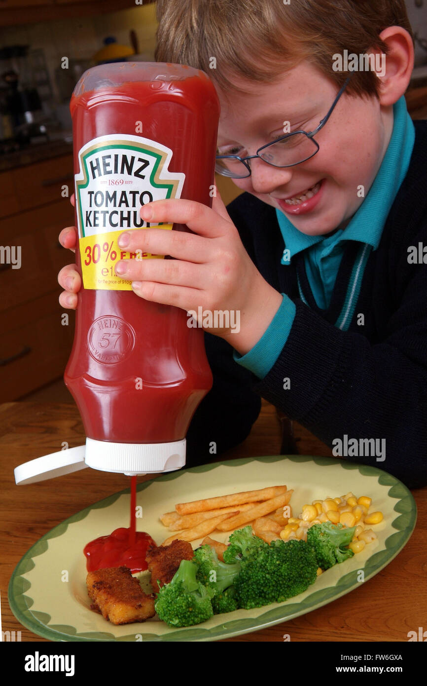 Young boys using Heinz tomato ketchup Stock Photo Alamy