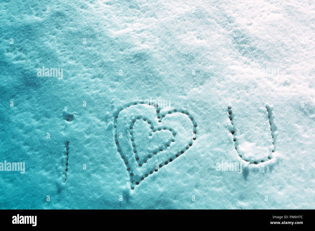 I love you with heart sign writing on the snow. Stock Photo