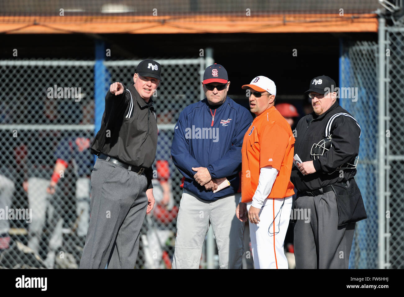 Prior to the start of a high school baseball games, head coaches meet with the umpire crew to discuss ground rules. USA. Stock Photo