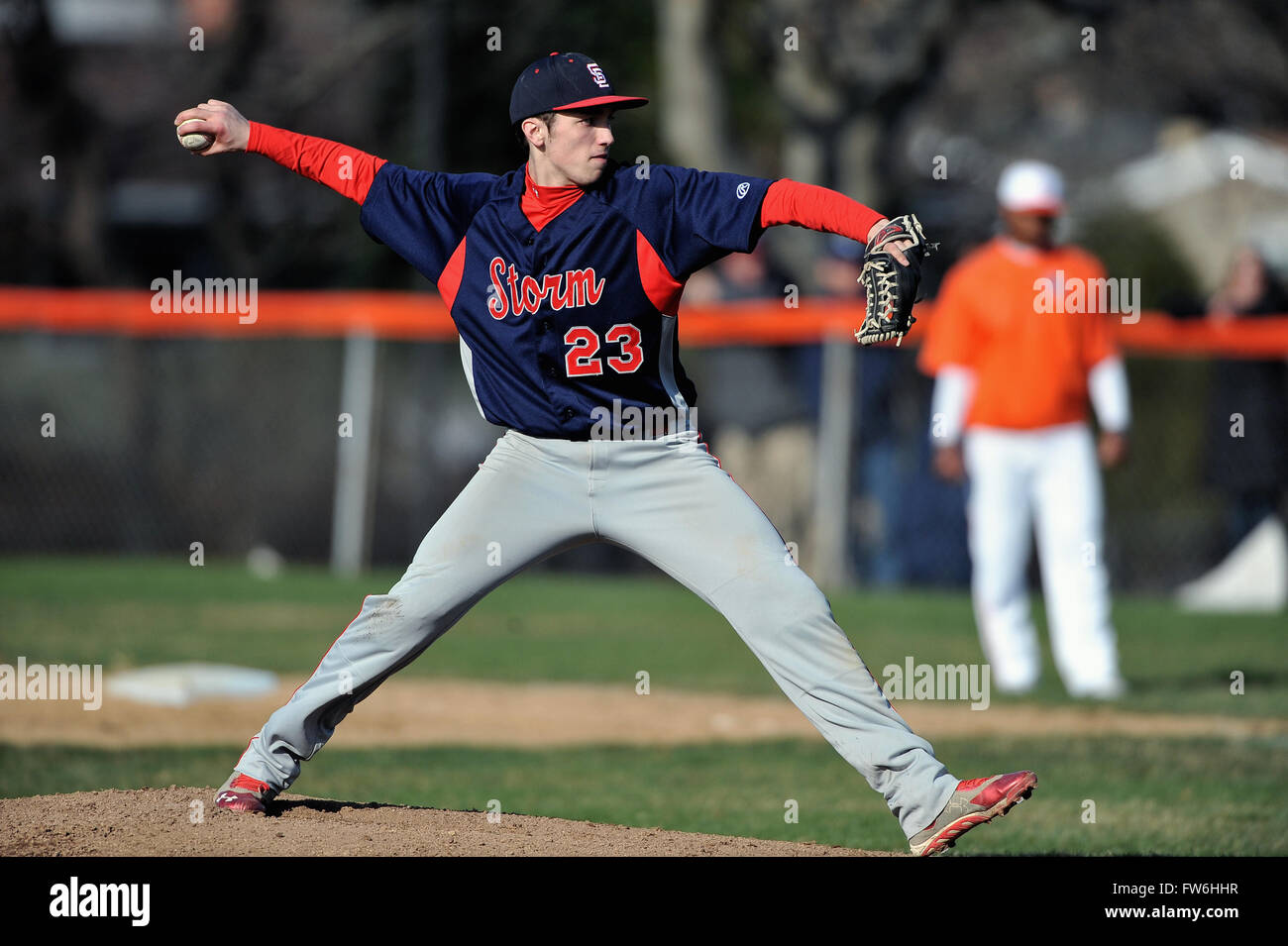 High school pitcher delivering a pitch during his start in an early