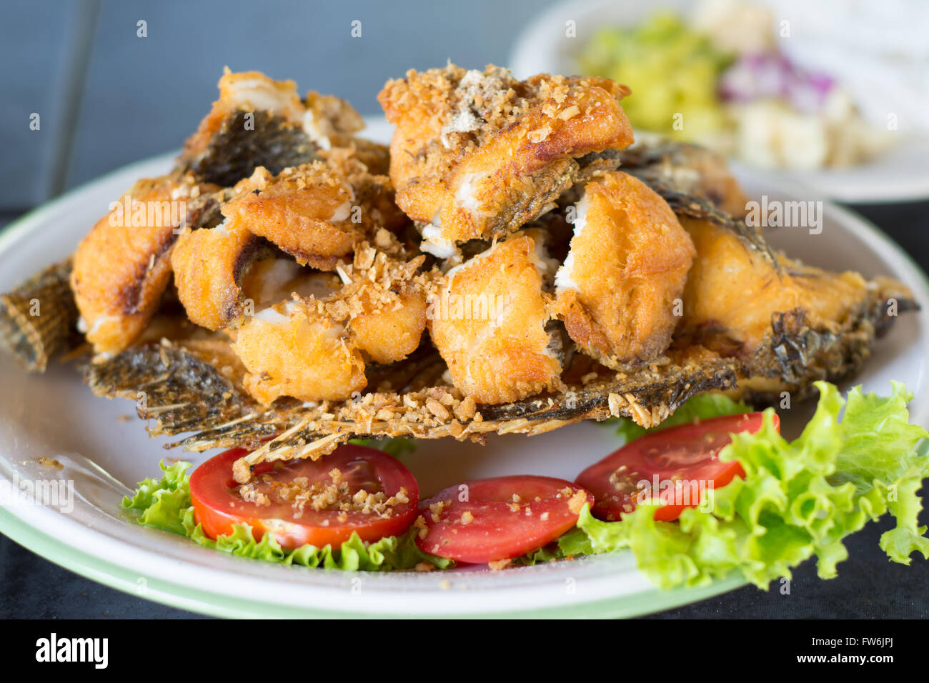Delicious fried tilapia fish in a plat Stock Photo