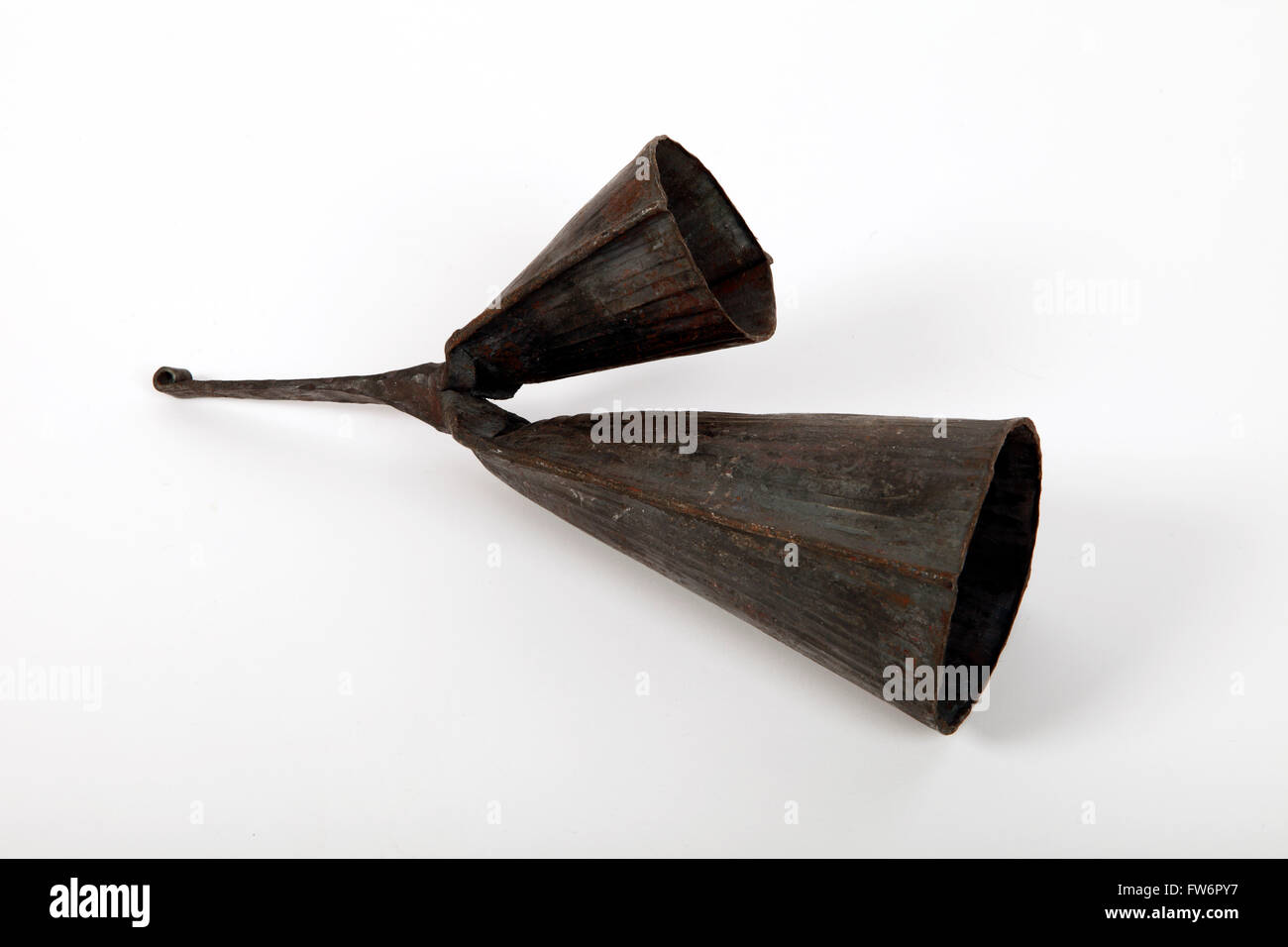 A Gankeke bell, two pitched African percussion instrument made of metal. The small cowbell is higher in pitch than the Stock Photo