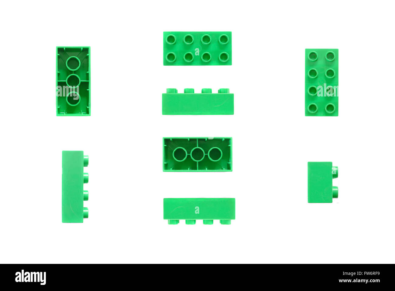 A selection of green Lego pieces photographed against a white background. Stock Photo