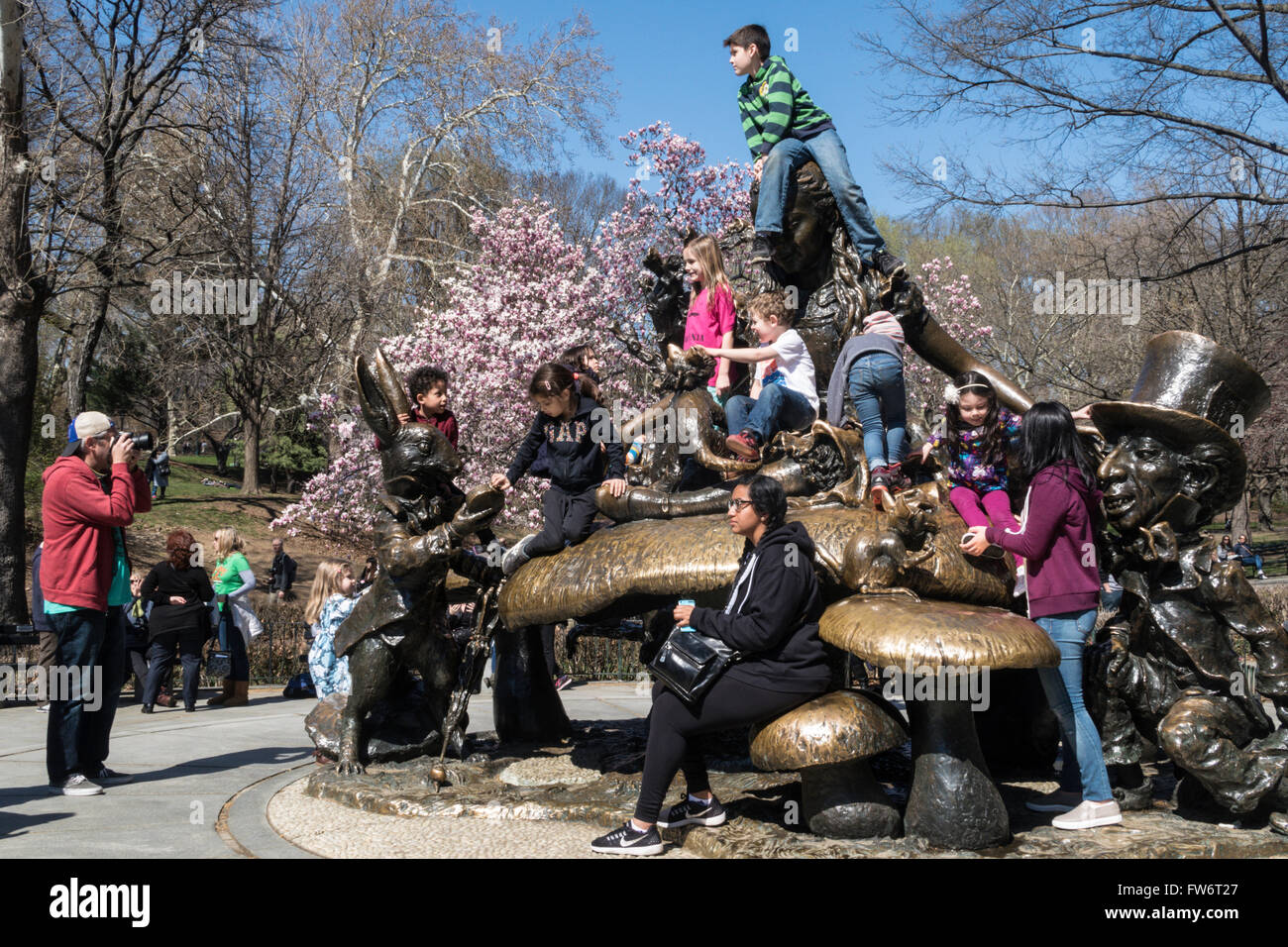 Tourists Flock to Alice in Wonderland Sculpture, Central Park, NYC