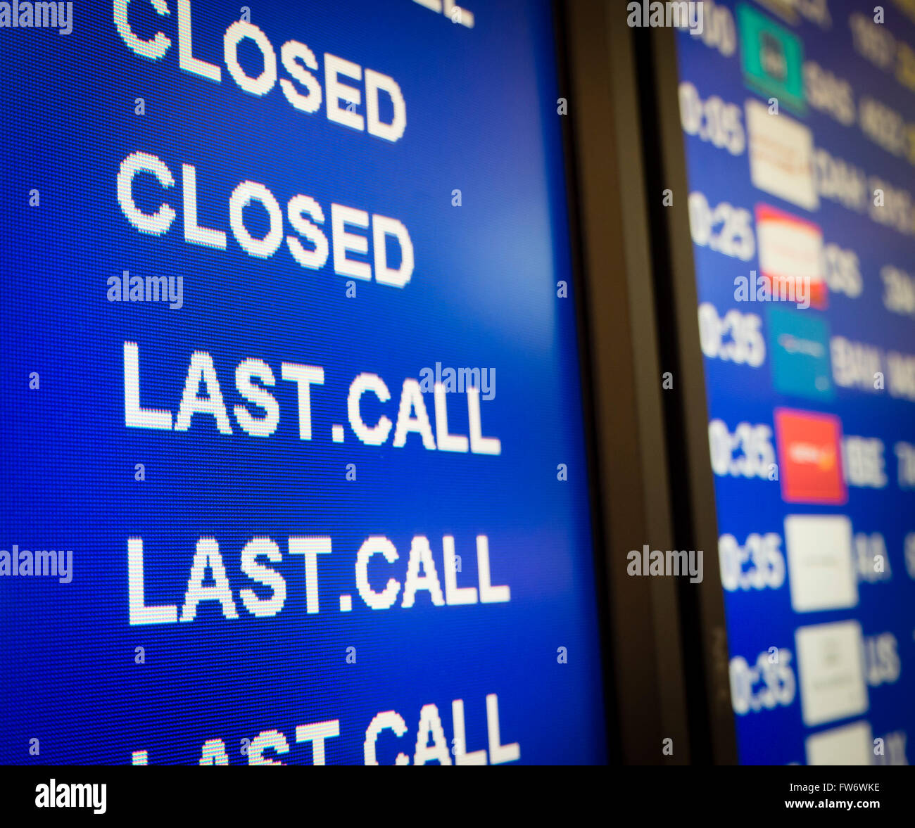Electronic annunciator panel at an airport showing 'Last Call' for boarding Stock Photo