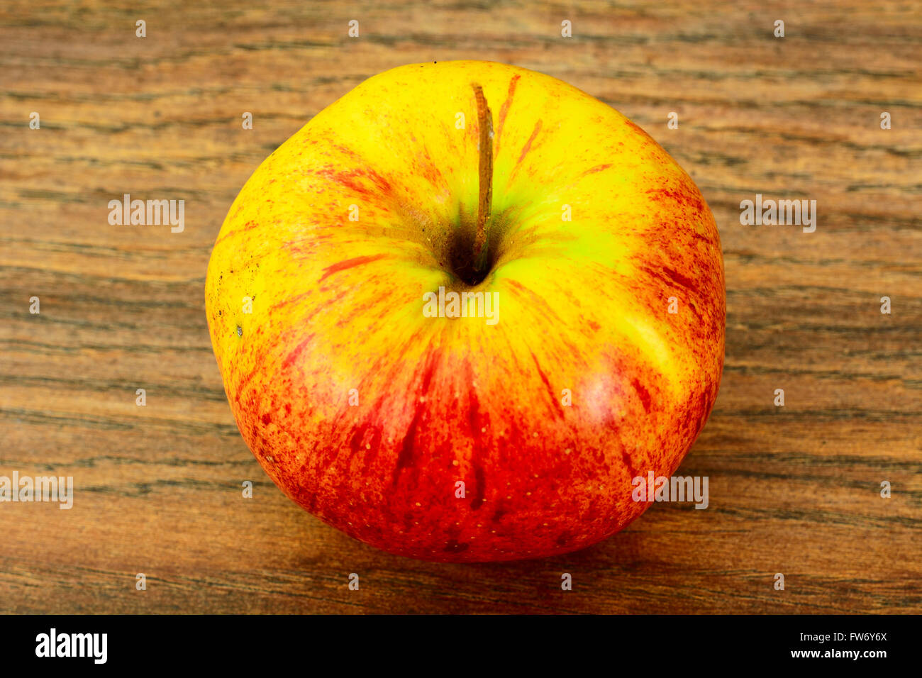Red Apple on Woody Background. Stock Photo
