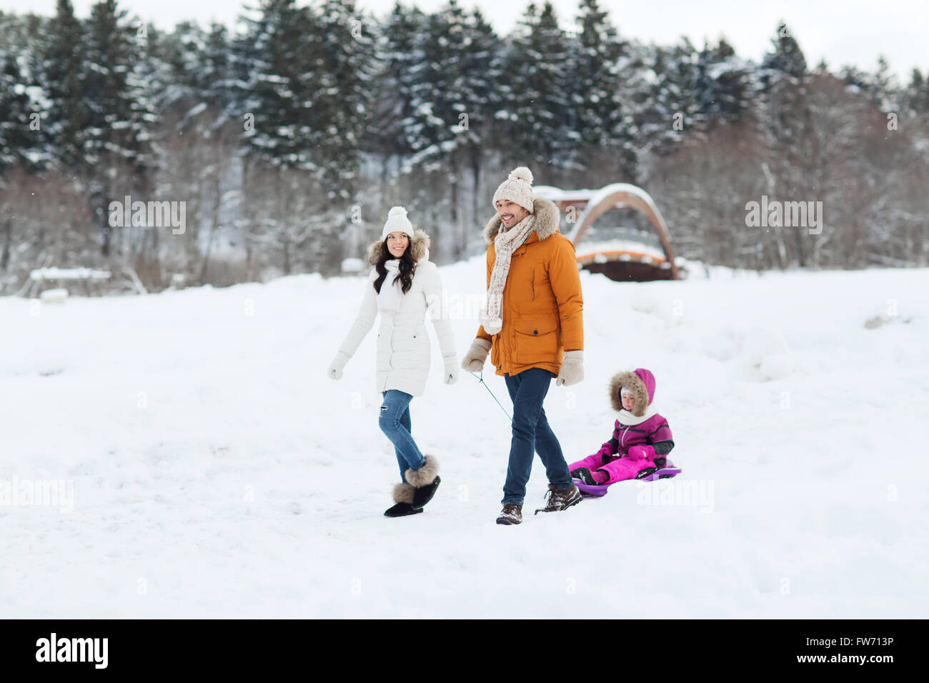 happy family with sled walking in winter forest Stock Photo - Alamy