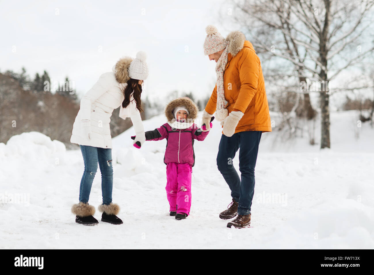 happy family in winter clothes walking outdoors Stock Photo - Alamy
