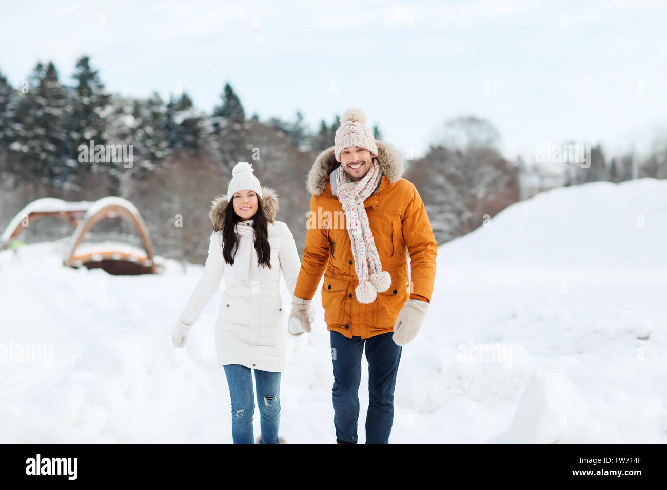 happy couple walking over winter background Stock Photo - Alamy