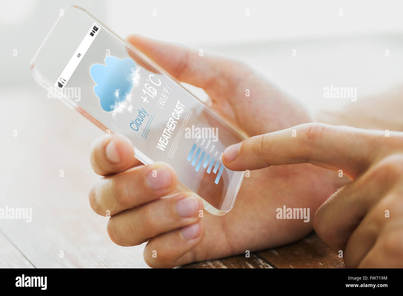 close up of male hand with weather cast smartphone Stock Photo