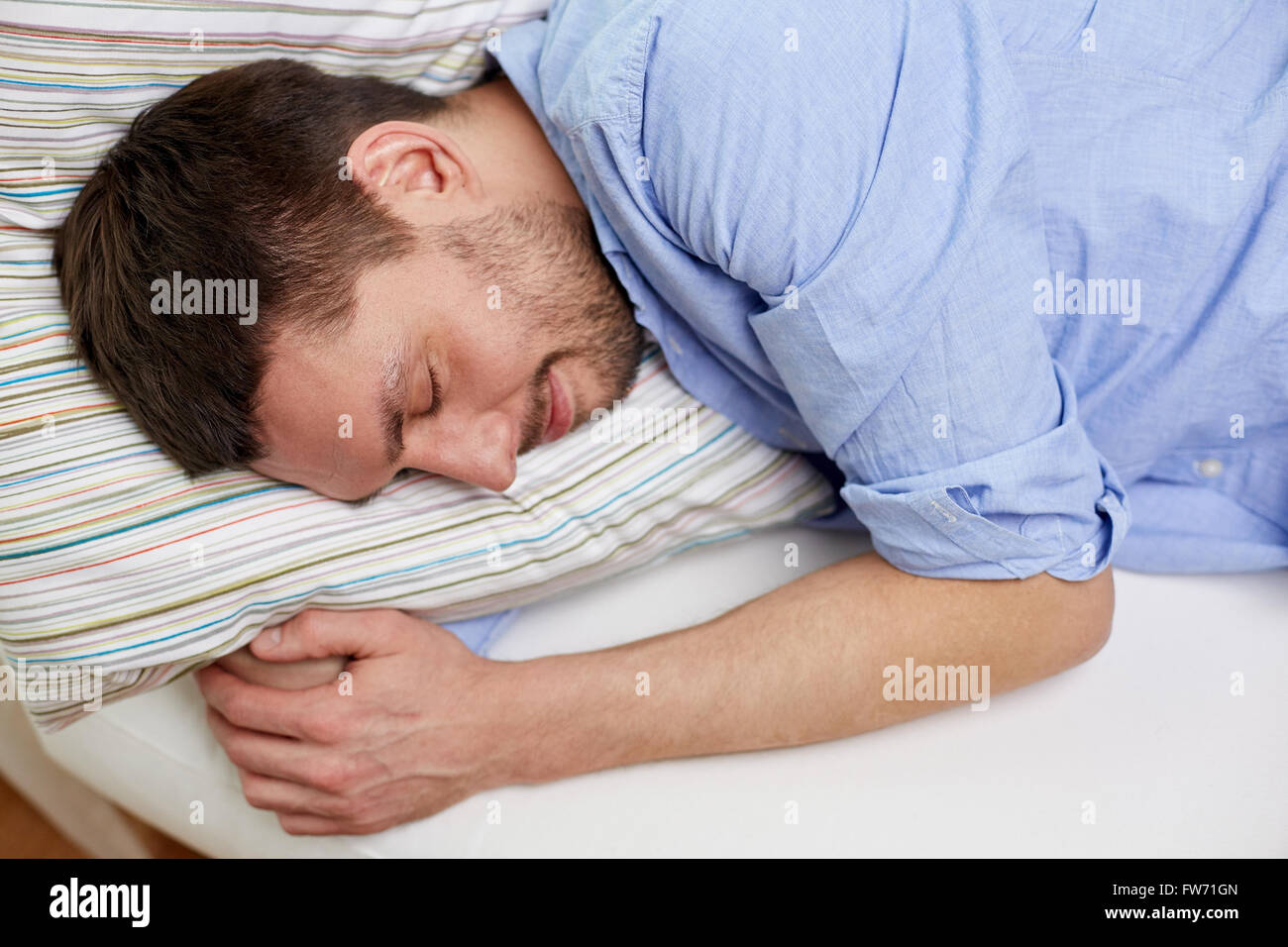 close up of  happy young man sleeping at home Stock Photo