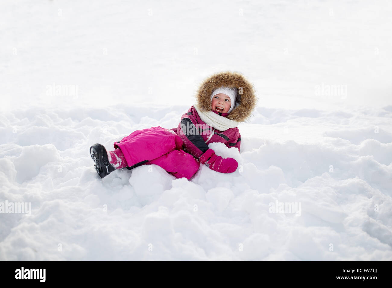 happy little kid or girl in winter clothes on snow Stock Photo - Alamy