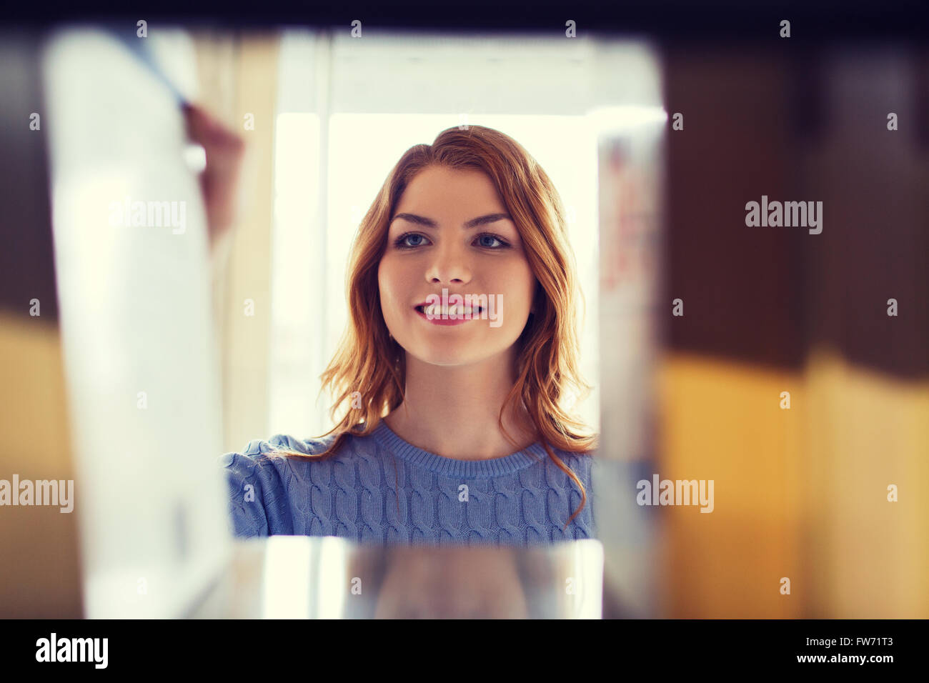 happy student girl or woman with book in library Stock Photo - Alamy