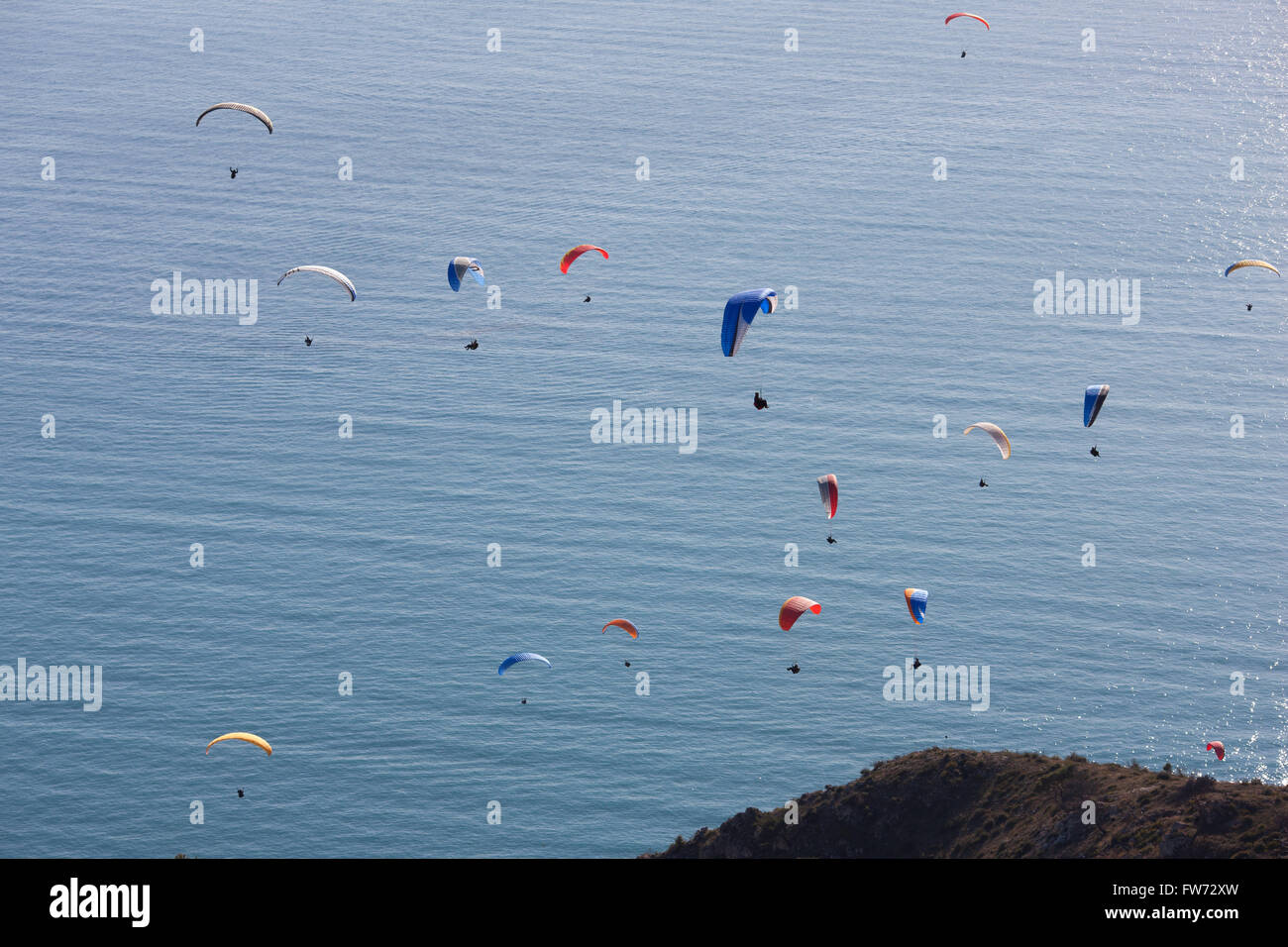 Cluster of 16 paragliders soaring over the Mediterranean Sea. Roquebrune-Cap-Martin, Alpes-Maritimes, French Riviera, France. Stock Photo