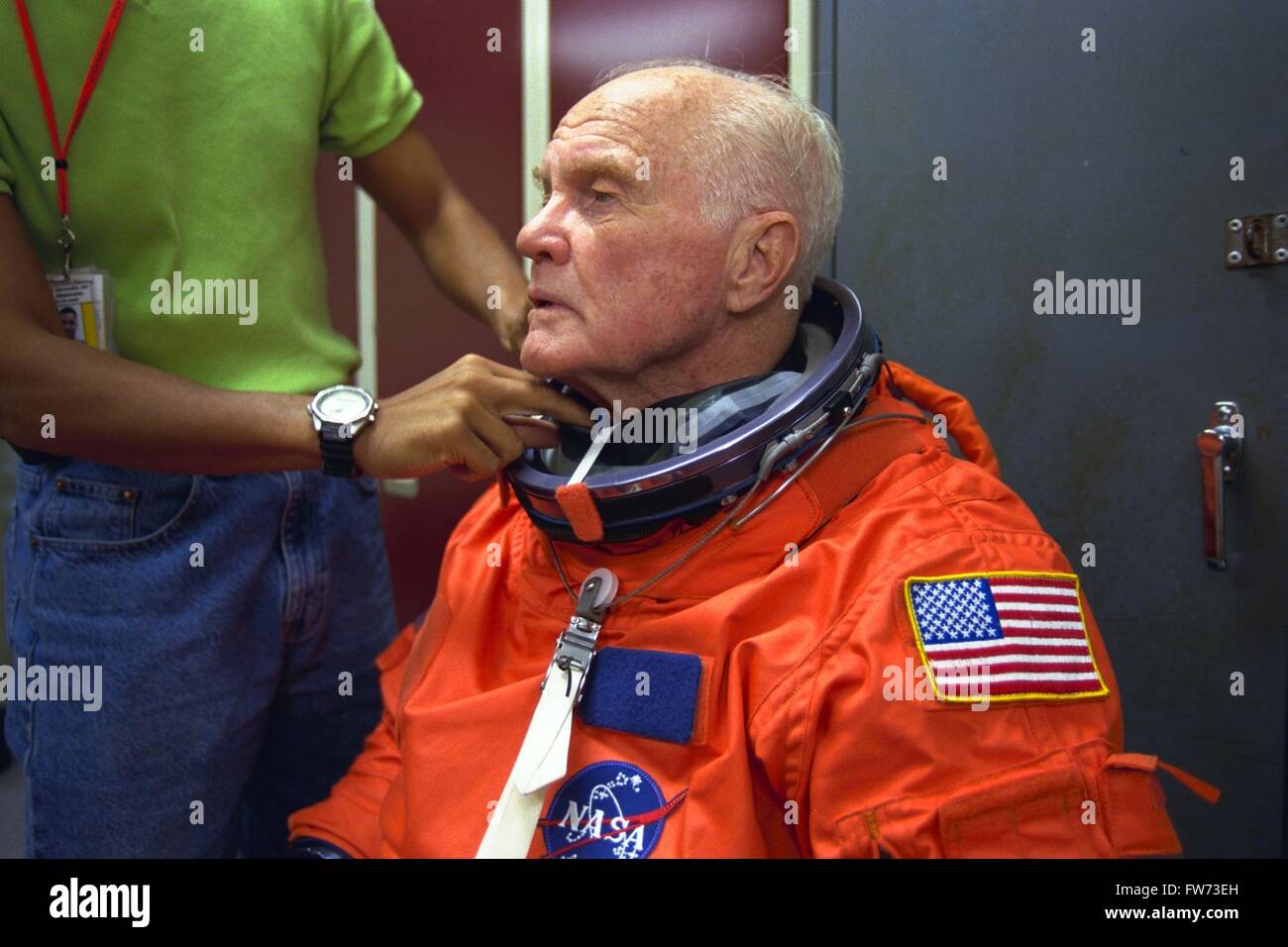 U.S. Senator and astronaut John Glenn is assisted in suiting up for a training exercise at the systems integration facility at the Johnson Space Center April 28, 1998 in Houston, Texas. Glenn who first flew in space in 1962 is scheduled to join the Space Shuttle Discovery STS-95 flight. Stock Photo