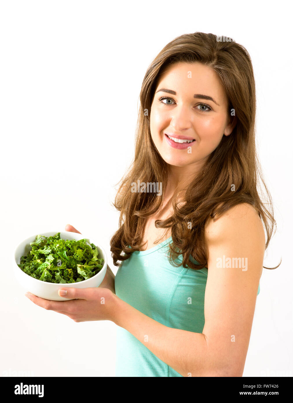Young woman with bowl of kale Stock Photo