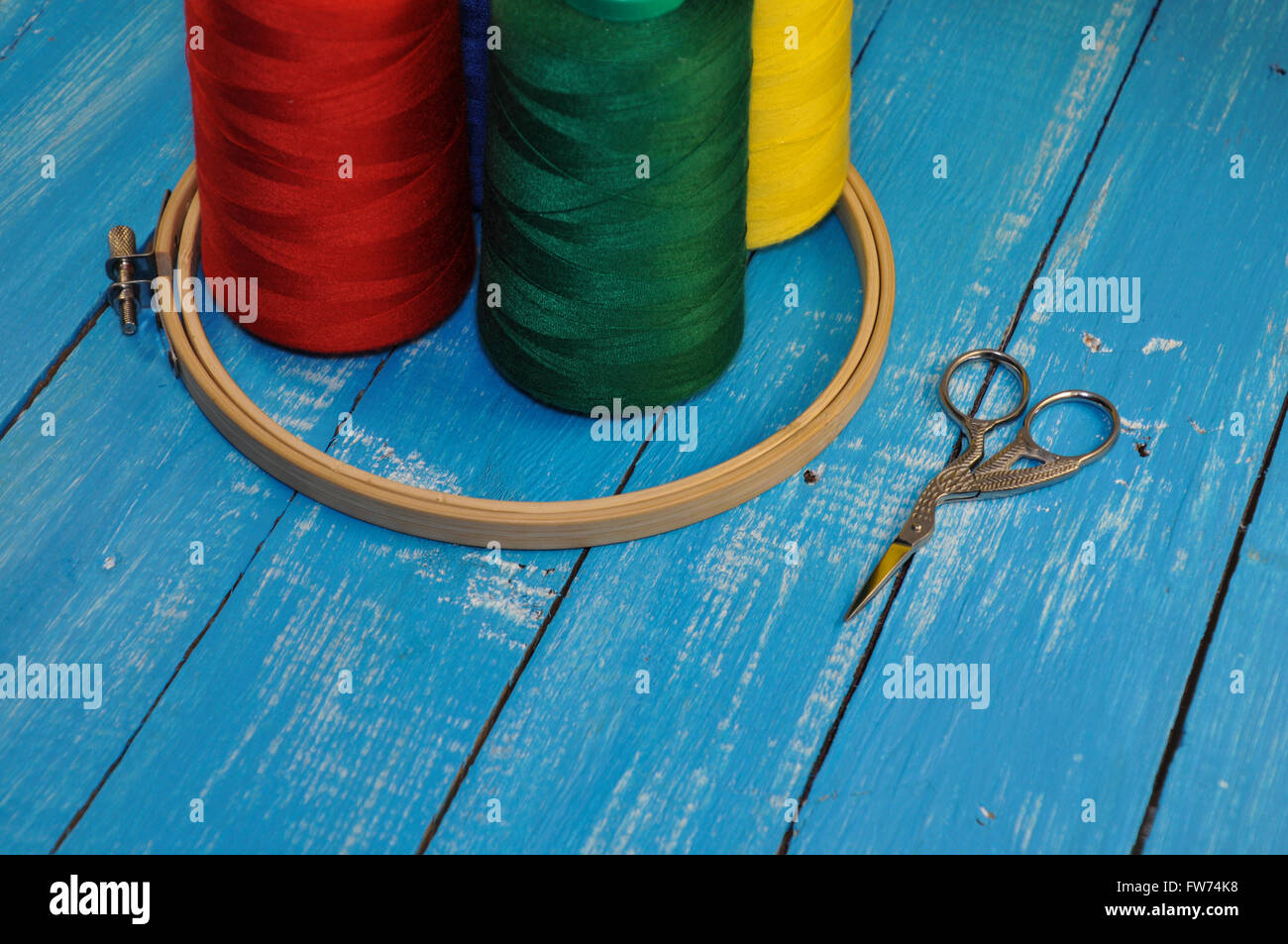 Thread Hoop Multicolored threads, hoop and scissors for sewing and embroidery on a ...