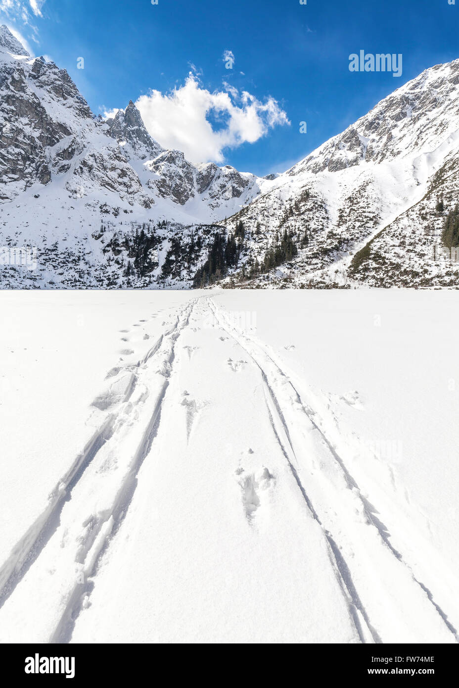 Cross-country skis traces on snow on frozen Lake Morskie Oko, Polish Tatra Mountains. Stock Photo