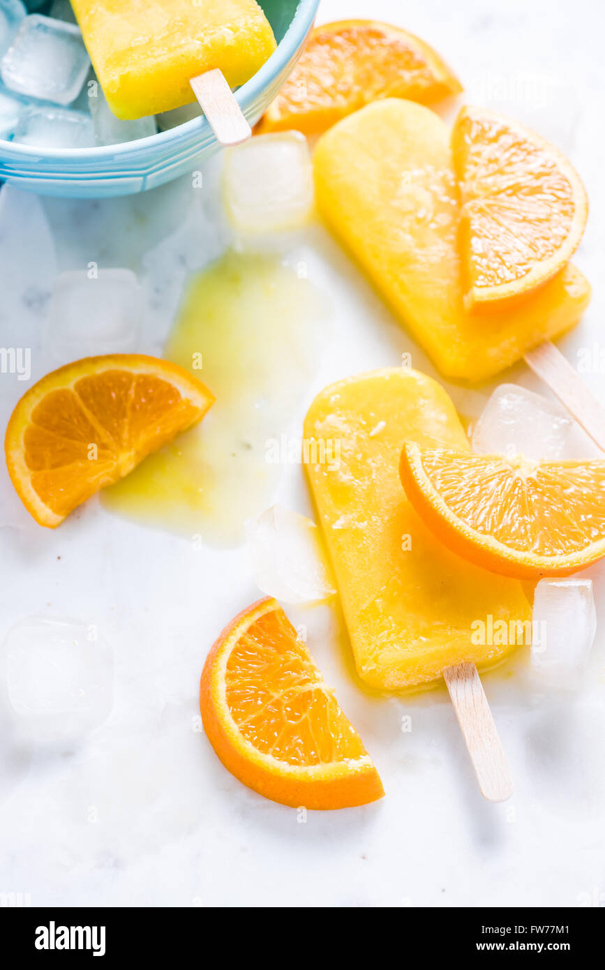 Refreshing popsicle, fruit slices and ice cubes, healthy summer sweet treat Stock Photo