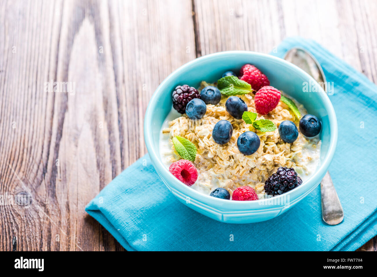 Tasty and light diet cereal breakfast with sumer fruits, fresh milk and honey. Diet concept and wellbeing. Stock Photo