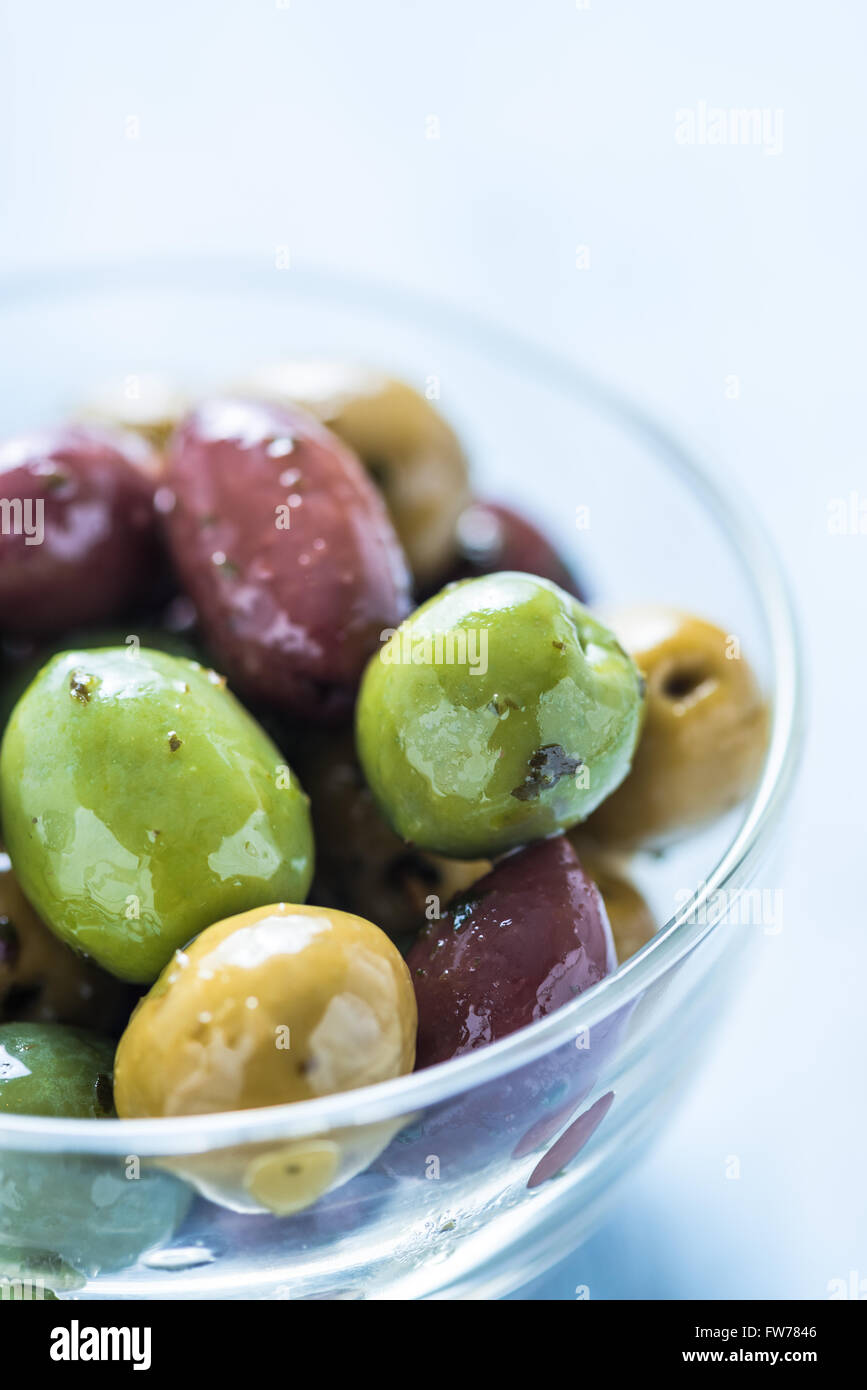 Fresh whole olives in bowl, with oil and spices.Spanish tapas concept. Stock Photo