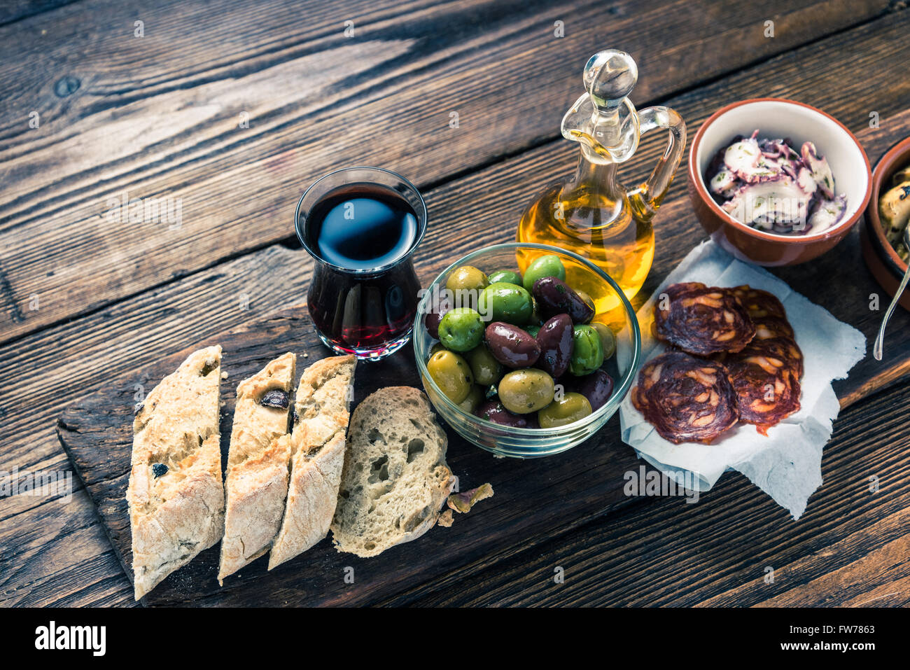Authentic spanish tapas on wooden board, tonned picture, from above Stock Photo